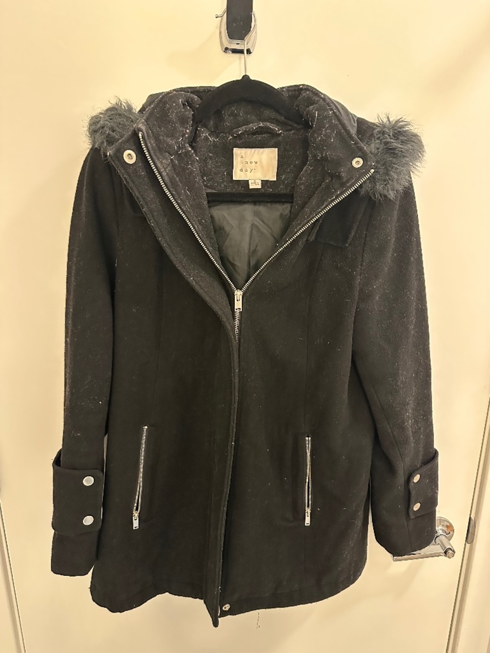 A New Day black coat